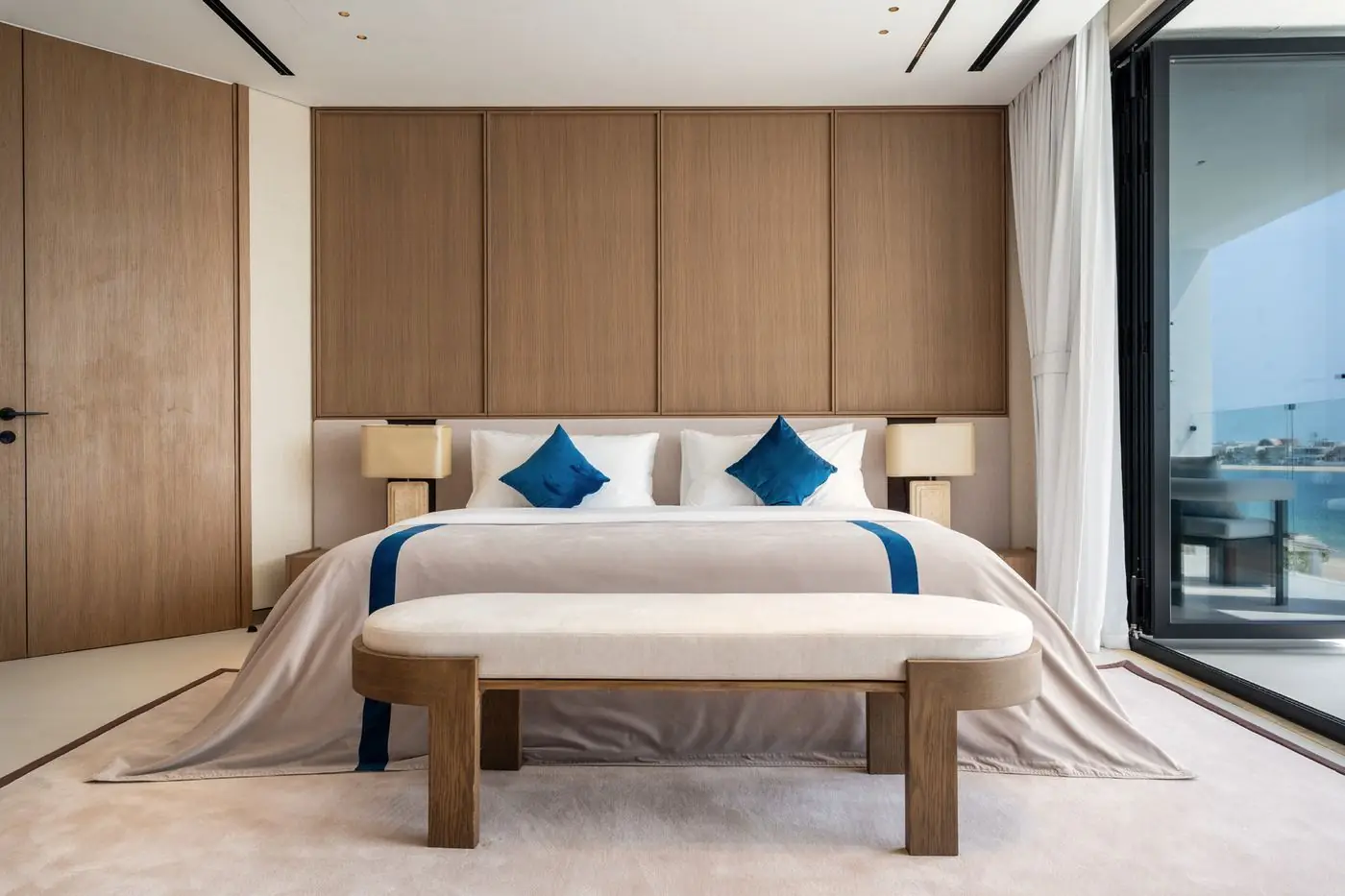 Bedroom with a full-width veneer headboard and sea view